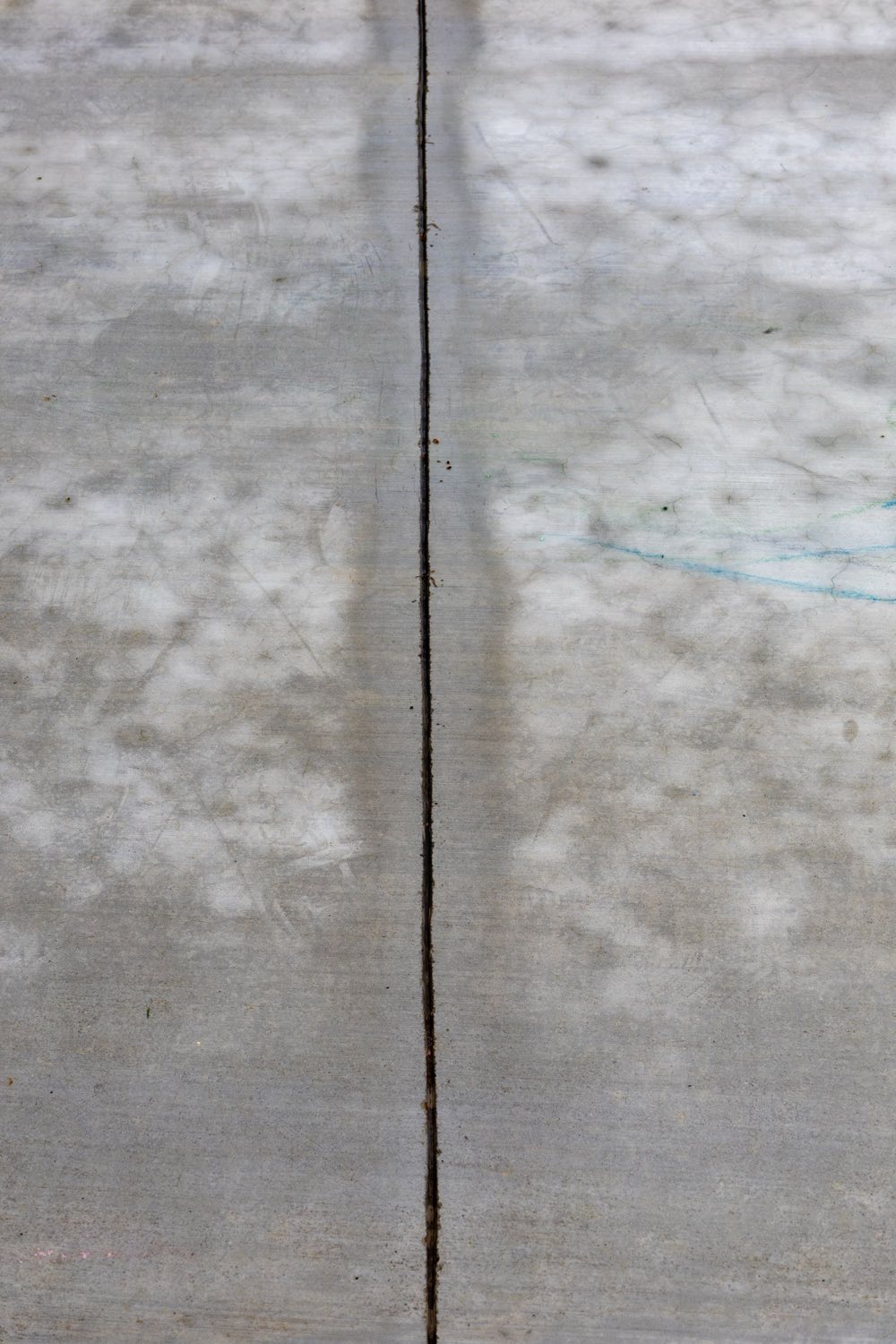 Concrete slab surface with a control joint and fine map cracking